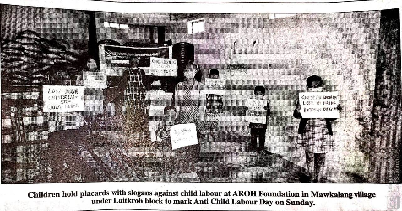 Children hold placards with slogans against child labour at AROH Foundation in Mawkalang village under Laitkroh block to mark Anti-Child Labour Day on Sunday